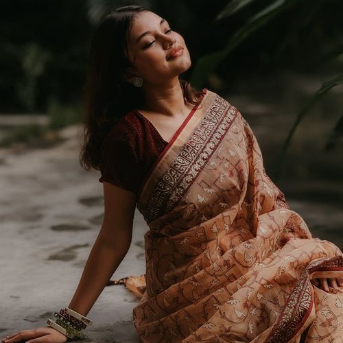 Portrait of a smiling woman in a calm setting.